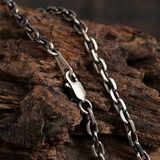 Diamond Cut Curb Chain draped over rustic wood, showing polished link surfaces and lobster clasp.