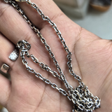 Diamond Cut Curb Chain pooled in an open palm, showing the links and clasp.
