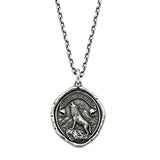 Rise Above wolf talisman pendant with mountain and crescent moon design on a chain, against a white background.