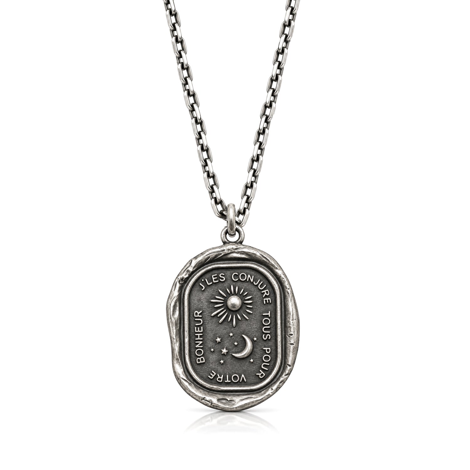Guided by the Stars talisman pendant with sun, crescent moon and stars on a chain against a white background.